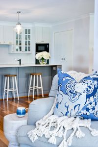 Hamptons Style Kitchen with Butler Pantry Pendant Lighting Custom Cushion by MotzDesigns White Wooden Accent Side Table Claudine Hand Knit Throw from Bed Bath & Table Powder Blue Armchair from Provincial Home Living Coffee Mug from Pillow Talk Hydrangea Phoebe Sphere Vase from Zane