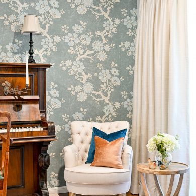 Claudette Robins Egg Thibaut wall covering with piano, Alessia Accent Chair, cushions in Zepel fabrics, Deborah Hutton Side Table
